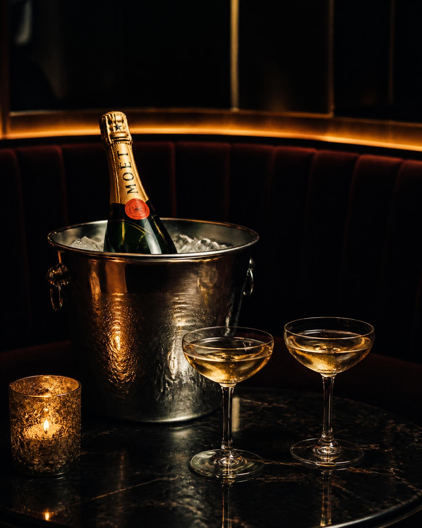 Champagne on ice with two coupe glasses